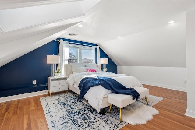 bedroom featuring hardwood / wood-style flooring and vaulted ceiling