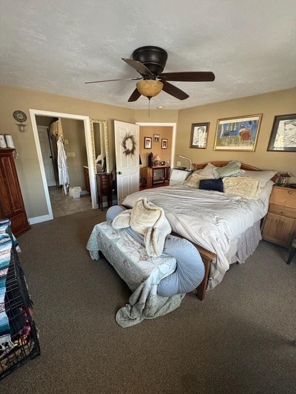 bedroom with light carpet, ceiling fan, a textured ceiling, and baseboards