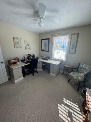 office with light carpet and ceiling fan