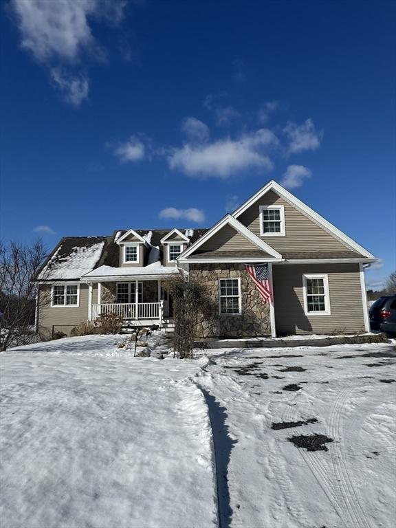 view of front of property with covered porch and stone siding