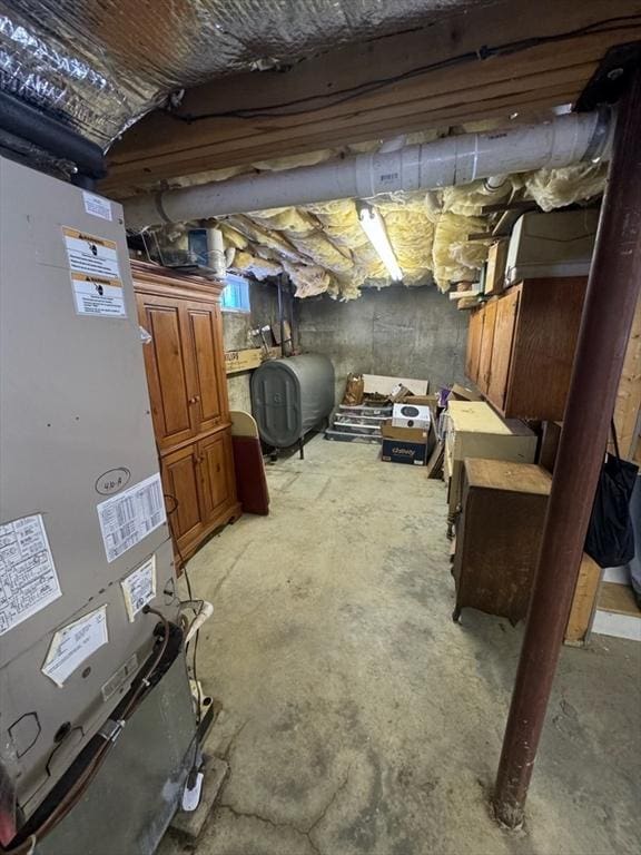 unfinished basement with heating unit and heating fuel