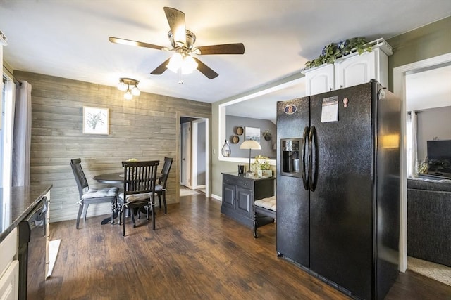 16 Kaveney St, Chicopee, MA 01020 - dining area with a ceiling fan, wooden walls, an accent wall, dark wood-type flooring, and baseboards