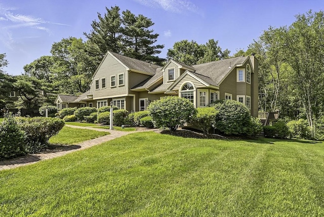 8 Birchwood Ln Unit 8, Hopkinton, MA 01748 - view of front of house featuring a front yard, a chimney, and a shingled roof