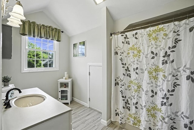 8 Birchwood Ln Unit 8, Hopkinton, MA 01748 - full bathroom with wood finished floors, vanity, vaulted ceiling, and curtained shower