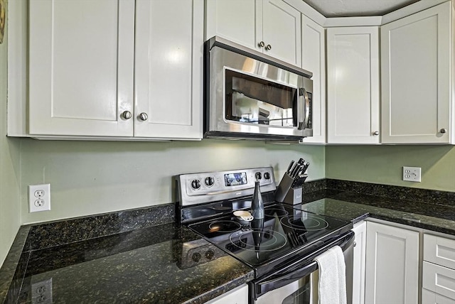 8 Birchwood Ln Unit 8, Hopkinton, MA 01748 - kitchen with appliances with stainless steel finishes, white cabinetry, and dark stone counters