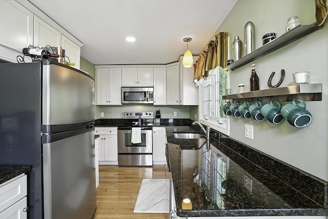 8 Birchwood Ln Unit 8, Hopkinton, MA 01748 - kitchen with stainless steel appliances, white cabinets, light wood-type flooring, dark stone countertops, and pendant lighting