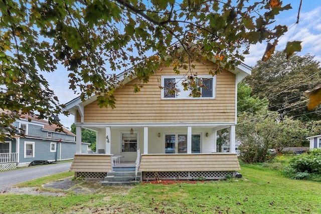 view of front of home featuring a front lawn and a porch