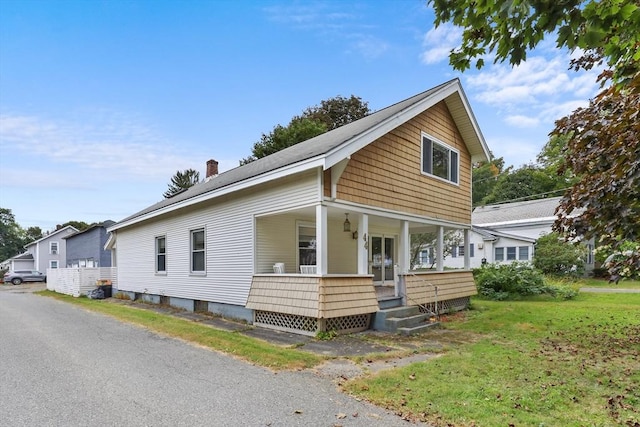 view of front of house featuring a front yard and a porch