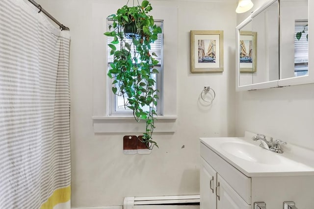 bathroom featuring a baseboard heating unit and vanity