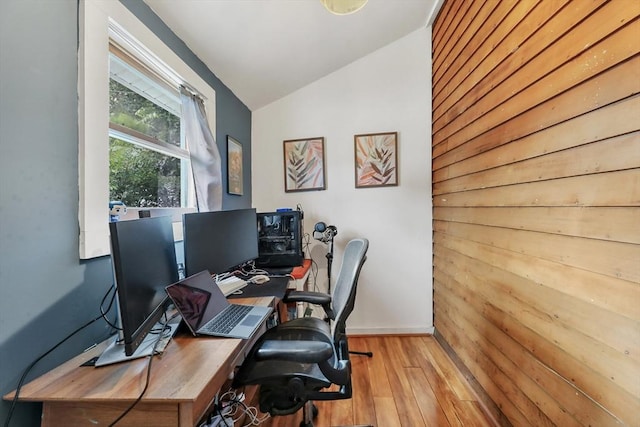 office area with light hardwood / wood-style floors and lofted ceiling