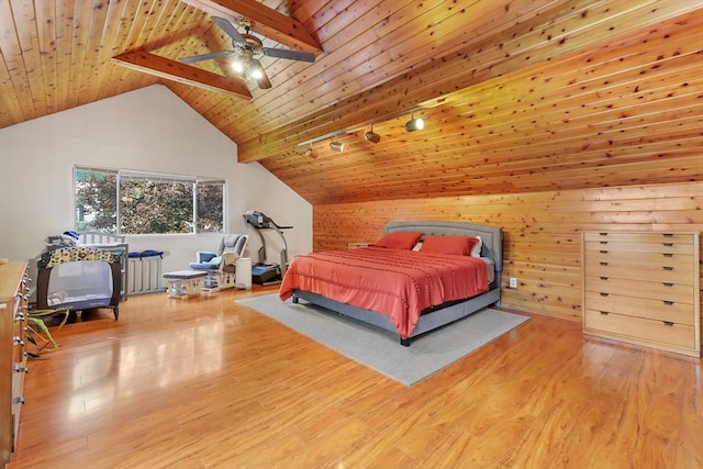 bedroom with beam ceiling, radiator heating unit, wood-type flooring, and wood ceiling