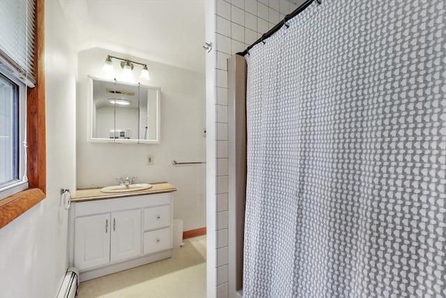 bathroom with vanity, a shower with shower curtain, and baseboard heating