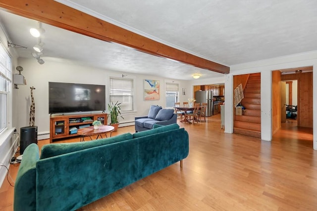 living room with light wood-type flooring and a baseboard heating unit