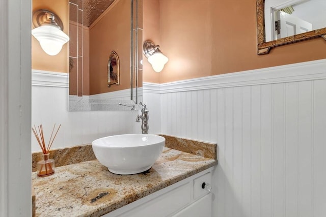 bathroom featuring vanity and a wainscoted wall