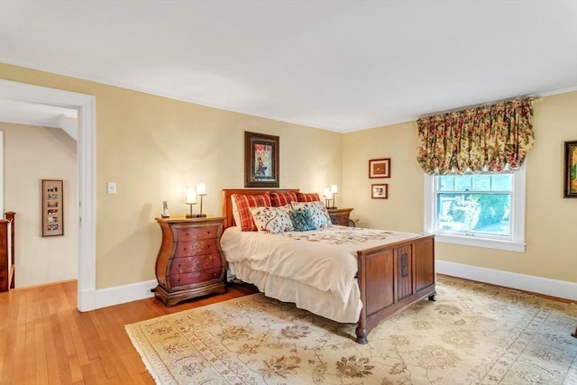 bedroom with baseboards and light wood-style floors