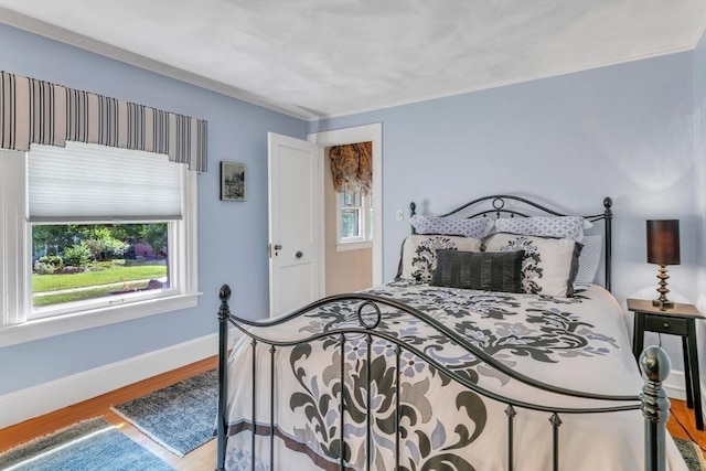 bedroom featuring baseboards and wood finished floors