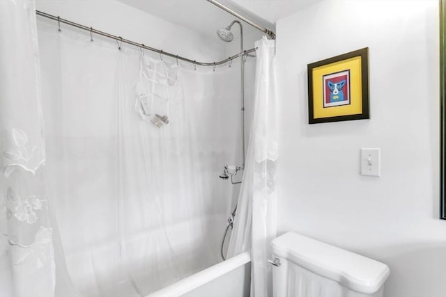 bathroom with toilet and shower / bath combo