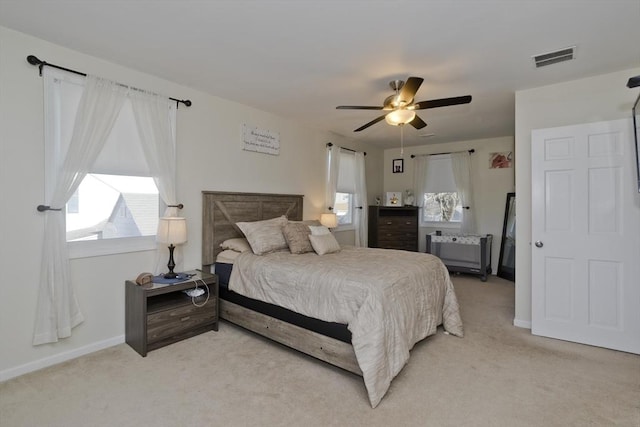 carpeted bedroom featuring ceiling fan and radiator heating unit