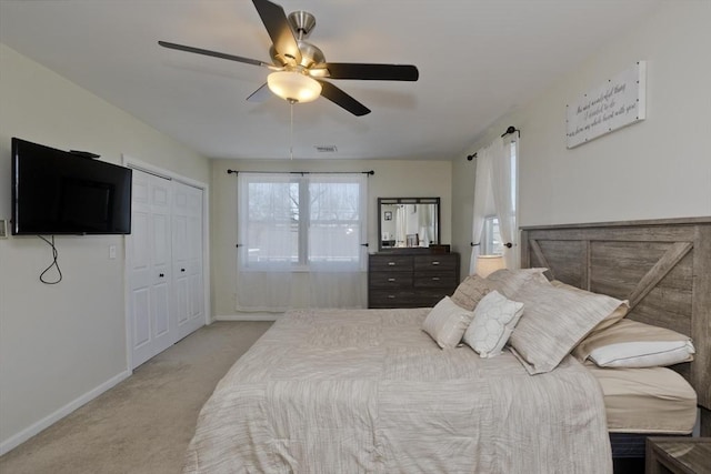 carpeted bedroom featuring a closet and ceiling fan