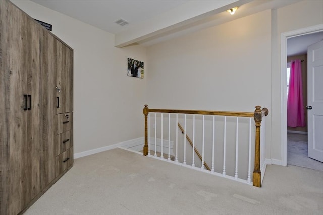 hallway featuring light colored carpet