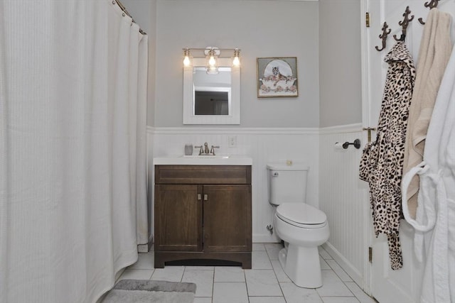 bathroom featuring vanity, toilet, and tile patterned flooring