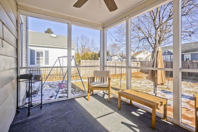 unfurnished sunroom featuring plenty of natural light and ceiling fan