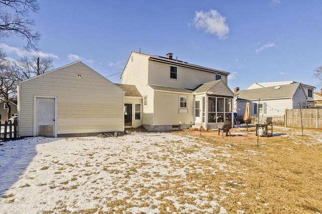 back of house featuring a sunroom