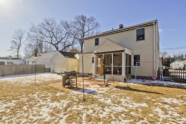 rear view of property featuring a sunroom