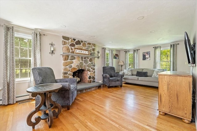 living area featuring wood finished floors, a fireplace, and recessed lighting