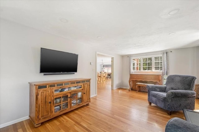 living room with light wood finished floors and baseboards