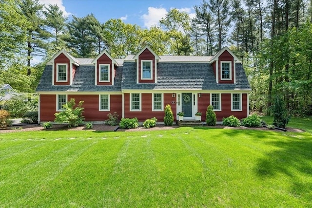 dutch colonial with a front yard and a shingled roof