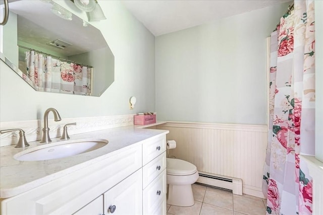 bathroom with a baseboard radiator, wainscoting, toilet, tile patterned floors, and vanity