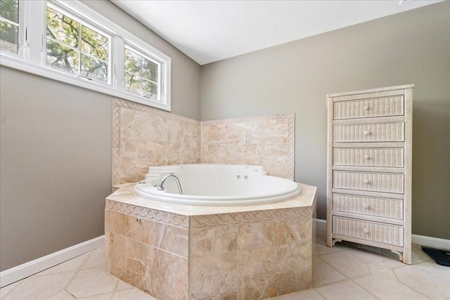 bathroom featuring tile patterned floors, a garden tub, and baseboards
