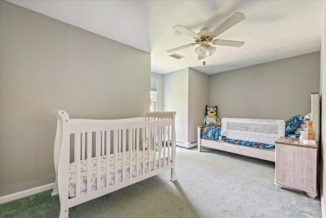 carpeted bedroom featuring baseboards and a ceiling fan