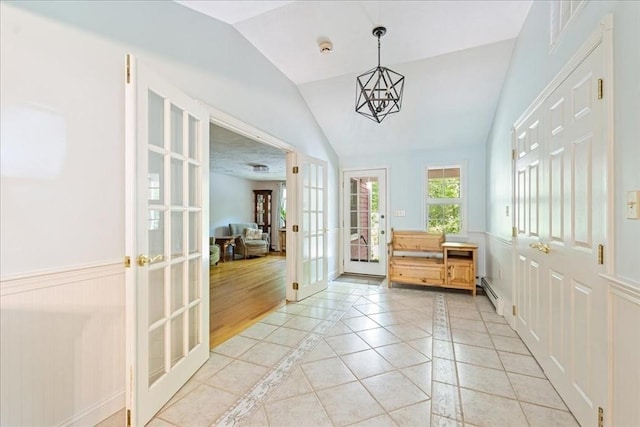 doorway with french doors, lofted ceiling, a baseboard radiator, inlaid floor details, and light tile patterned flooring