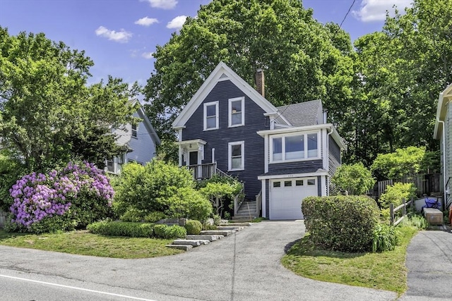 453 Washington St, Gloucester, MA 01930 - view of front facade featuring a chimney, a garage, and driveway