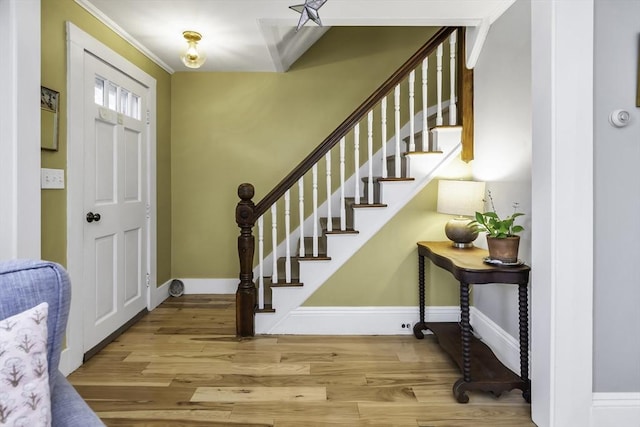 453 Washington St, Gloucester, MA 01930 - entryway with wood finished floors, stairs, baseboards, and crown molding