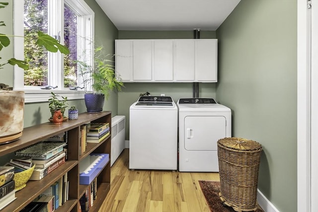 453 Washington St, Gloucester, MA 01930 - washroom with cabinet space, washer and clothes dryer, and light wood-type flooring