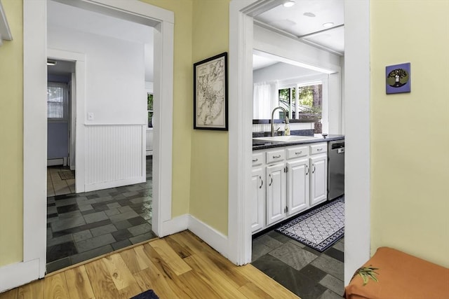 453 Washington St, Gloucester, MA 01930 - bar with dishwasher, a sink, a baseboard heating unit, and baseboards