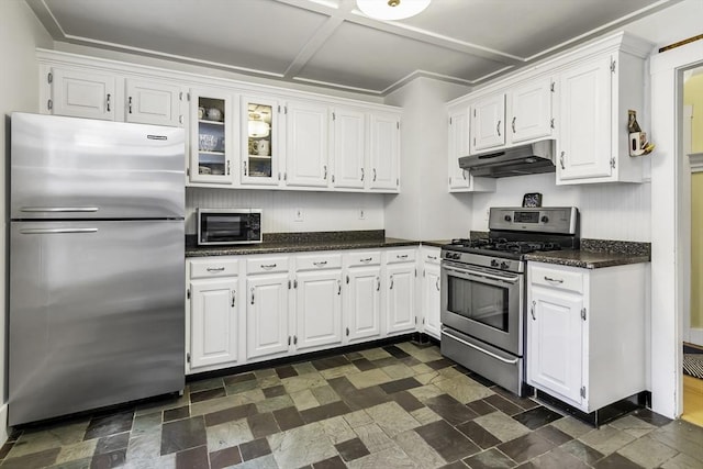 453 Washington St, Gloucester, MA 01930 - kitchen with stainless steel appliances, under cabinet range hood, white cabinetry, and glass insert cabinets