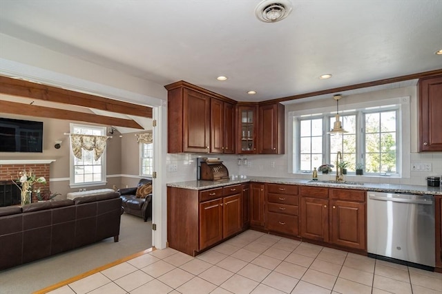 kitchen featuring plenty of natural light, open floor plan, a sink, and dishwasher