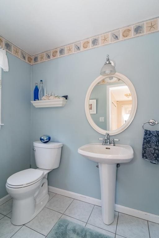 bathroom featuring baseboards, toilet, and tile patterned floors