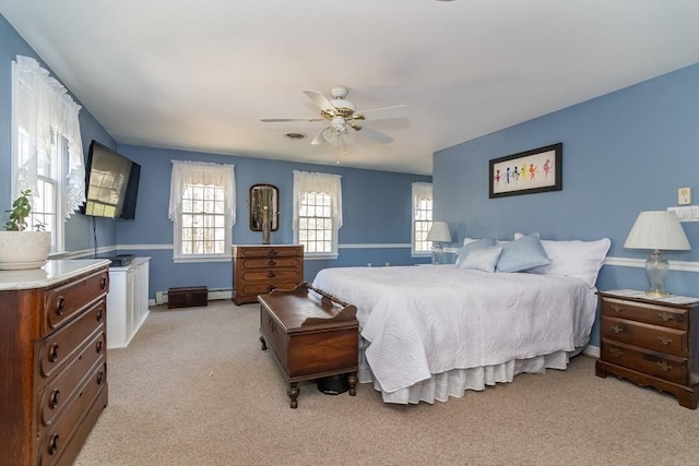 bedroom featuring ceiling fan, light colored carpet, and baseboards