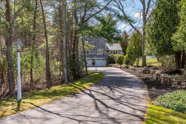 view of front of house featuring an attached garage and aphalt driveway