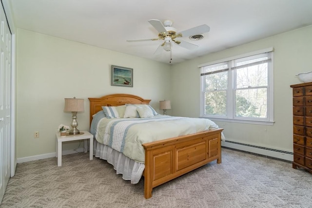 bedroom with visible vents, a ceiling fan, a baseboard heating unit, and light colored carpet