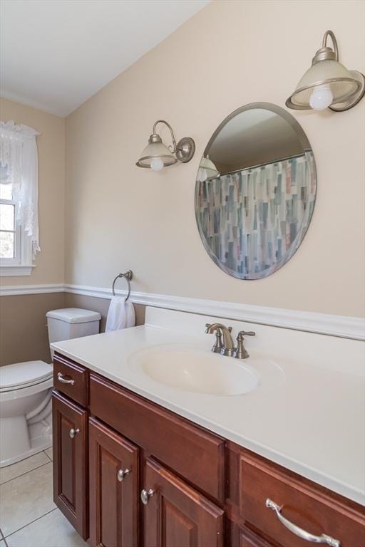 full bathroom with toilet, tile patterned flooring, and vanity