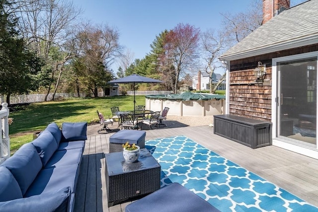 view of patio / terrace with outdoor dining area, an outdoor living space, a wooden deck, and fence