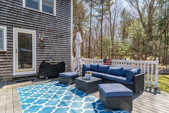deck with an outdoor living space and area for grilling