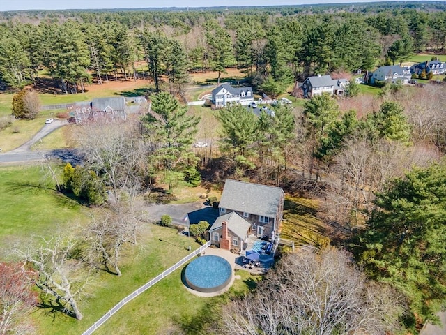 birds eye view of property with a view of trees