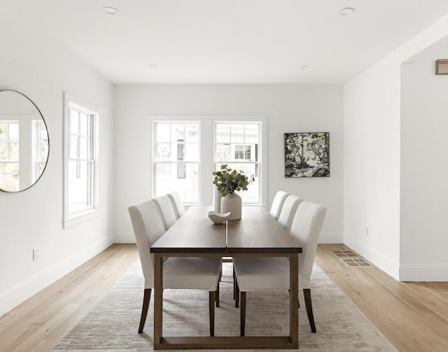 dining space featuring light hardwood / wood-style flooring and a healthy amount of sunlight